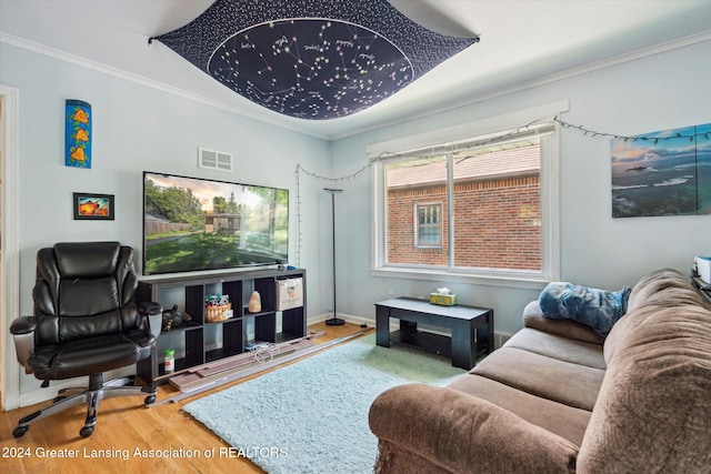 living room with hardwood / wood-style flooring and crown molding