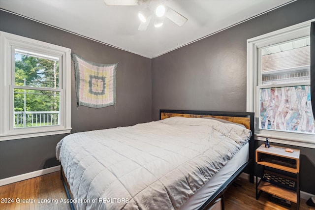 bedroom with ceiling fan and dark hardwood / wood-style floors