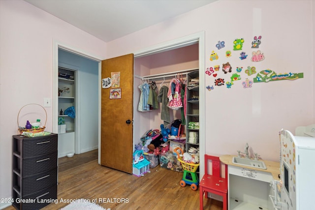 bedroom with hardwood / wood-style flooring and a closet