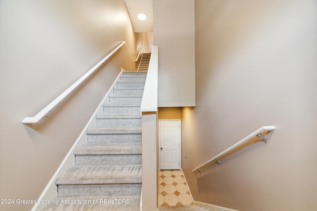 stairs featuring tile patterned flooring