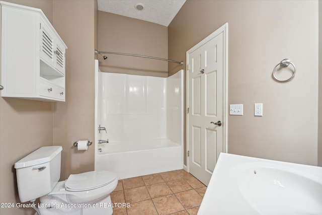 bathroom featuring tile patterned flooring, toilet, a textured ceiling, and shower / bath combination