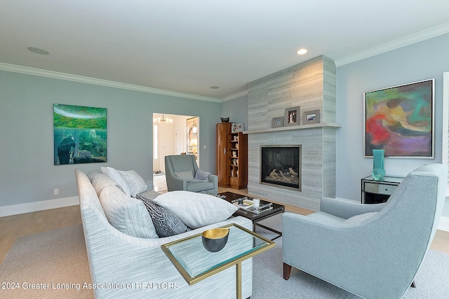 living room with crown molding, hardwood / wood-style flooring, and a fireplace