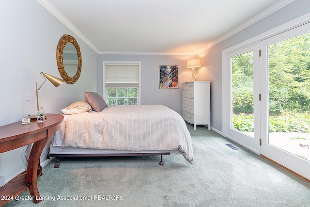 carpeted bedroom with crown molding, multiple windows, and access to outside