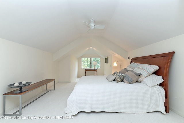 carpeted bedroom with ceiling fan and vaulted ceiling