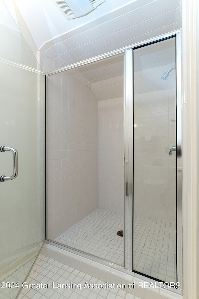 bathroom featuring a shower with door and tile patterned floors