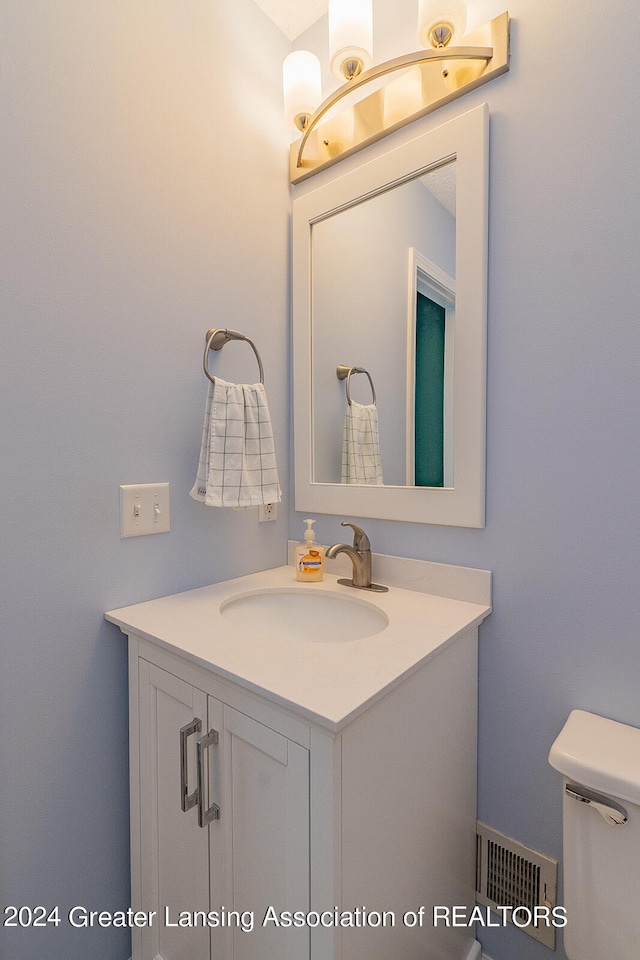 bathroom featuring toilet and vanity