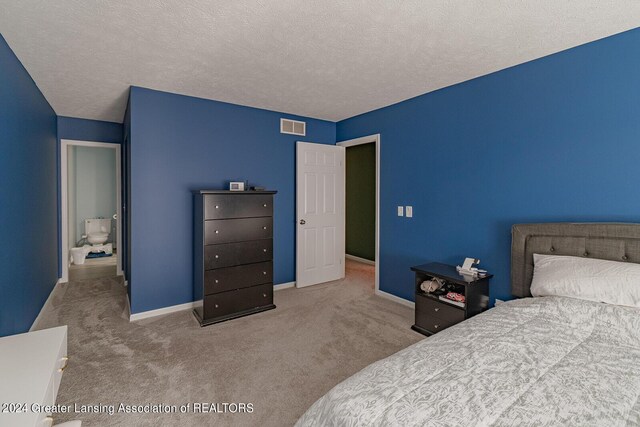 carpeted bedroom featuring a textured ceiling