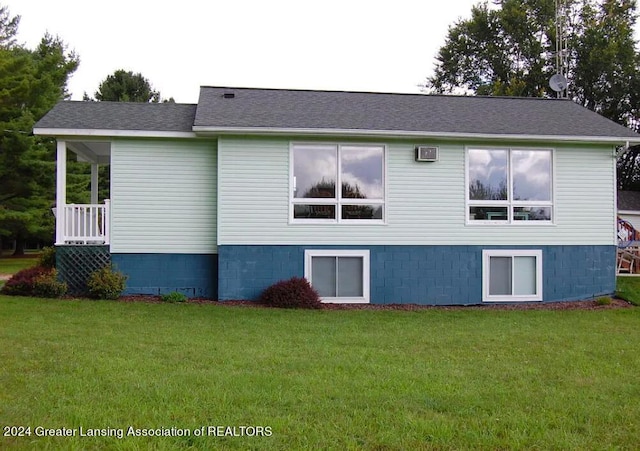 view of side of property with a yard