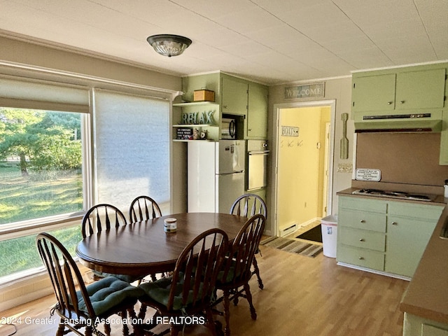 dining area featuring baseboard heating and light wood-style flooring