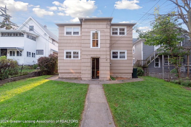 rear view of property with a yard