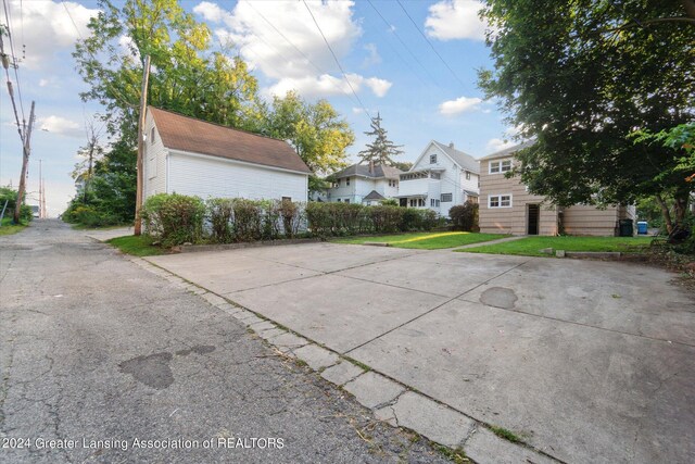 view of side of home with a lawn and a residential view