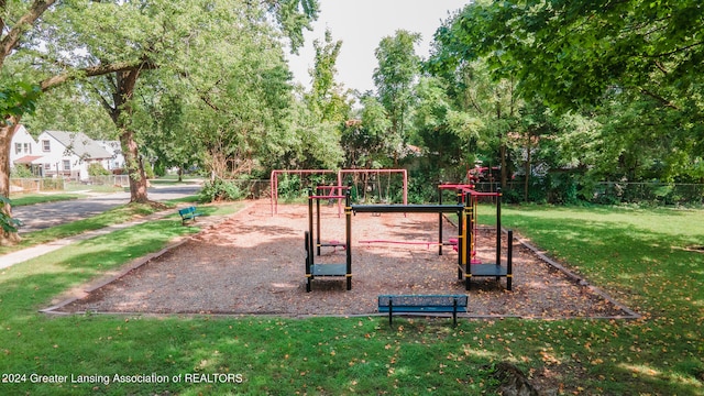 view of property's community with a playground and a yard