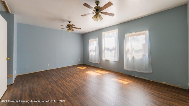 unfurnished room featuring ceiling fan and dark hardwood / wood-style floors