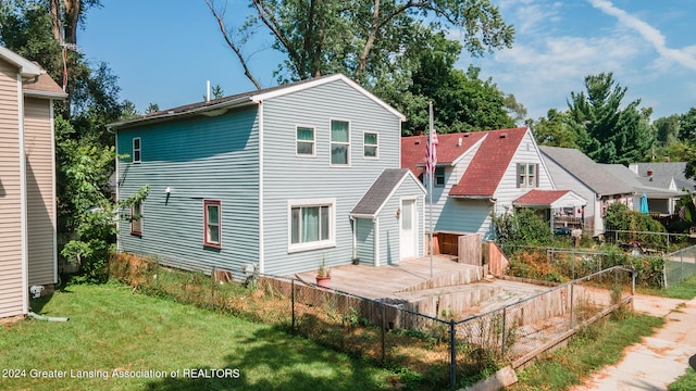 back of property featuring a lawn