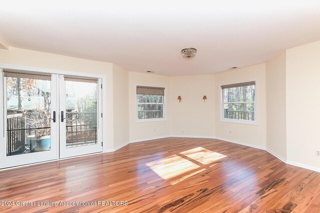 8425 Oakside St, Portage, MI 49002 - empty room with light wood finished floors, baseboards, and french doors