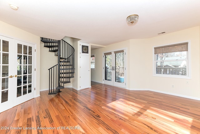 empty room featuring wood-type flooring and french doors