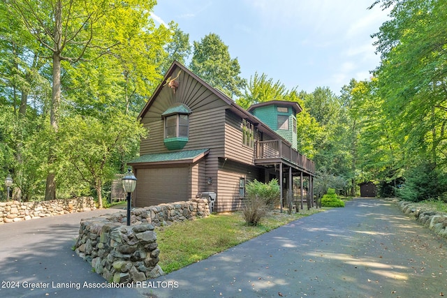 8425 Oakside St, Portage, MI 49002 - view of side of property featuring asphalt driveway and an attached garage