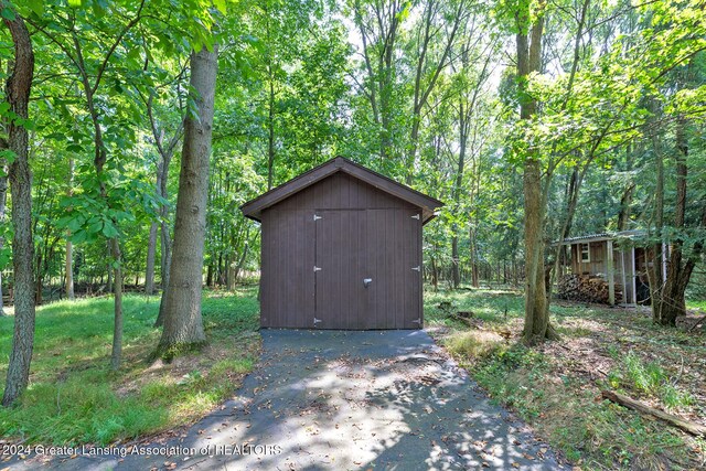 8425 Oakside St, Portage, MI 49002 - view of shed featuring a wooded view