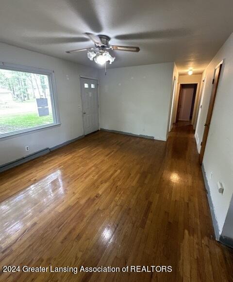 empty room featuring wood-type flooring and ceiling fan