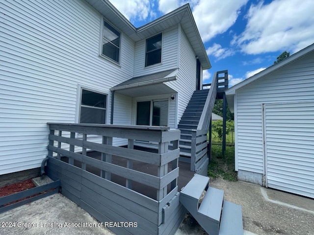 exterior space featuring stairway and a wooden deck