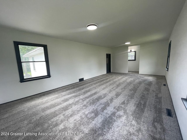 empty room featuring carpet floors and visible vents