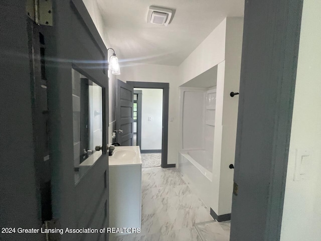 full bathroom with marble finish floor, visible vents, vanity, baseboards, and a bath