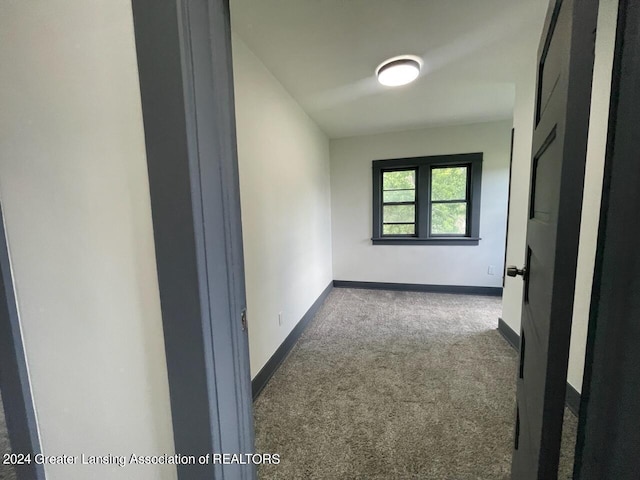 corridor featuring carpet and baseboards