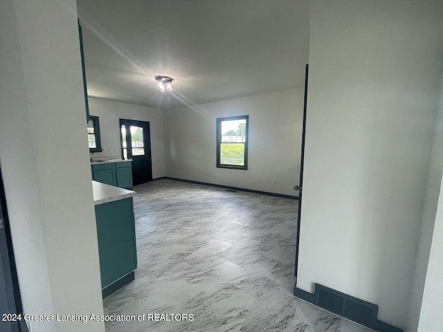 unfurnished room with marble finish floor and visible vents