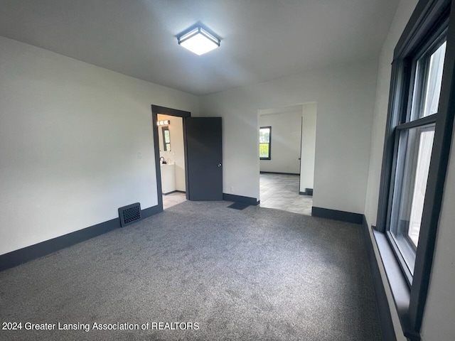 unfurnished room featuring visible vents and baseboards