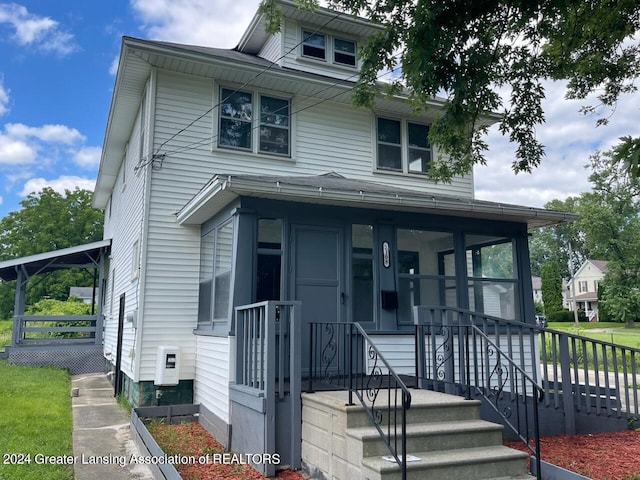 american foursquare style home featuring covered porch