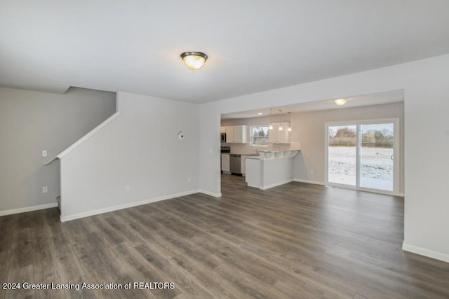 unfurnished living room featuring dark wood-type flooring