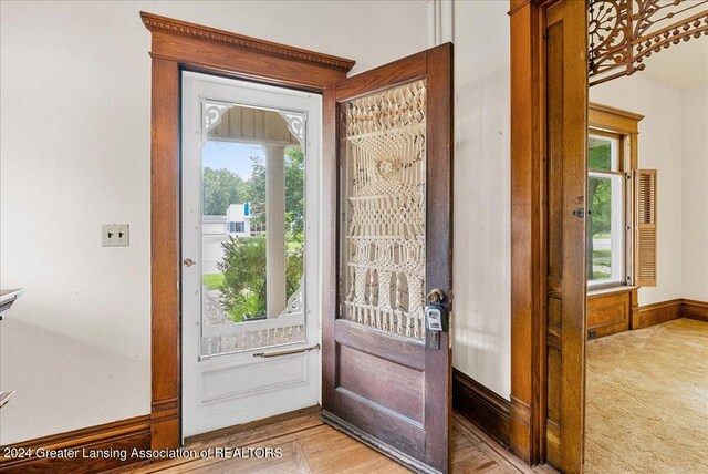 foyer entrance featuring light carpet