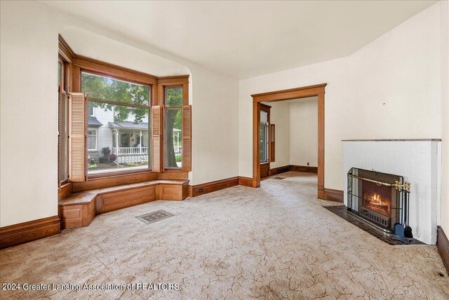 unfurnished living room with carpet