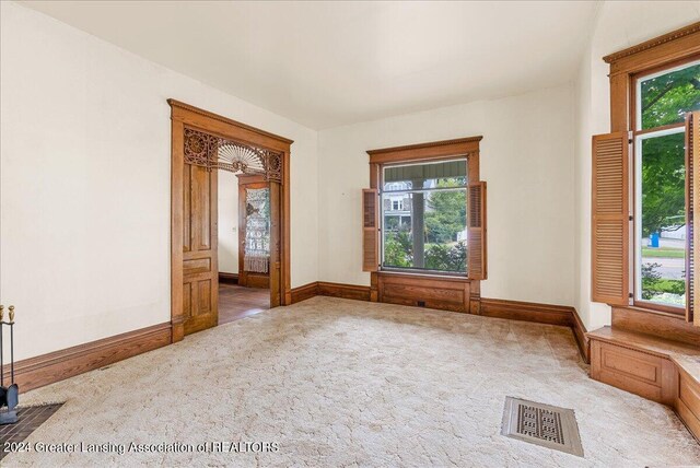 spare room with light colored carpet