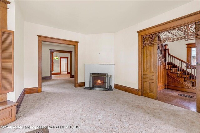 unfurnished living room featuring carpet flooring