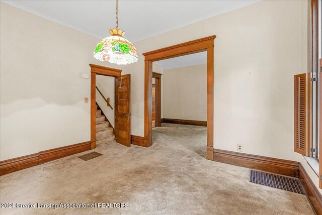 carpeted empty room with ornamental molding