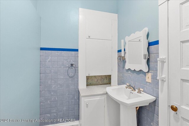 bathroom with tile walls