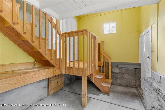 staircase with concrete floors