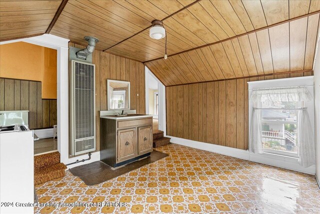 additional living space featuring lofted ceiling, wood walls, and wood ceiling