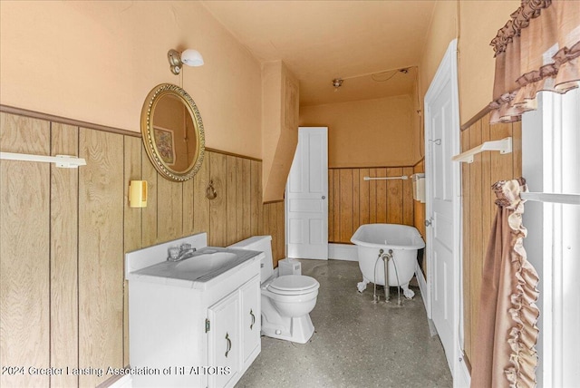 bathroom featuring toilet, wooden walls, a washtub, and vanity