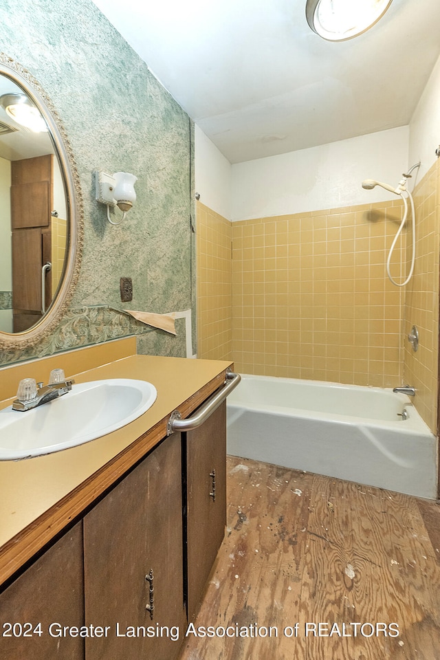 bathroom featuring tiled shower / bath combo, vanity, and hardwood / wood-style flooring