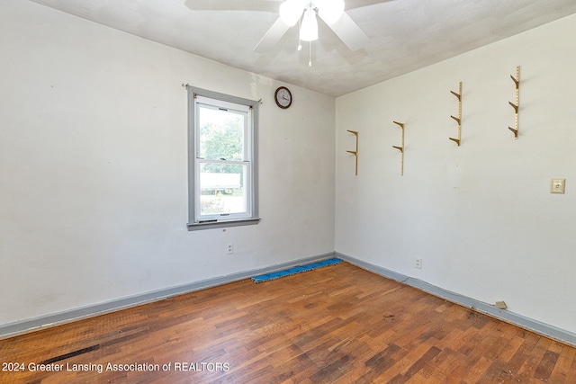 spare room with hardwood / wood-style flooring and ceiling fan