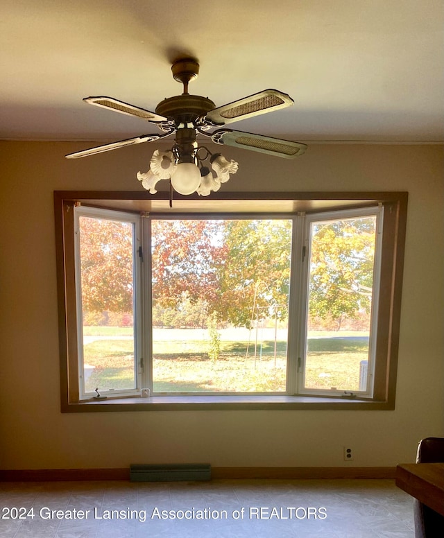 interior space with ceiling fan