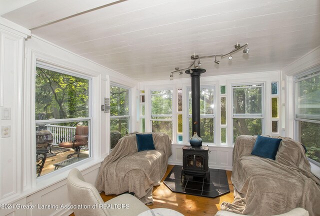 sunroom / solarium with a wood stove