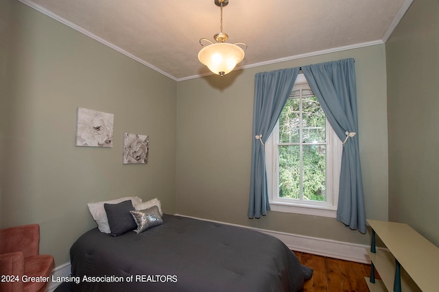 bedroom featuring ornamental molding and dark hardwood / wood-style floors