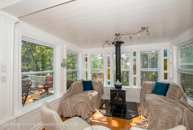 sunroom featuring a wood stove