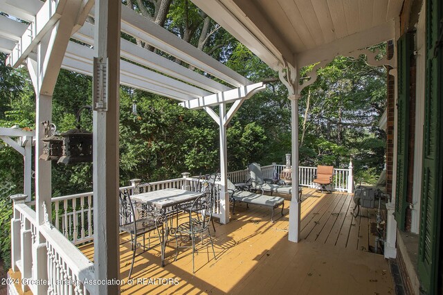 wooden deck featuring a pergola