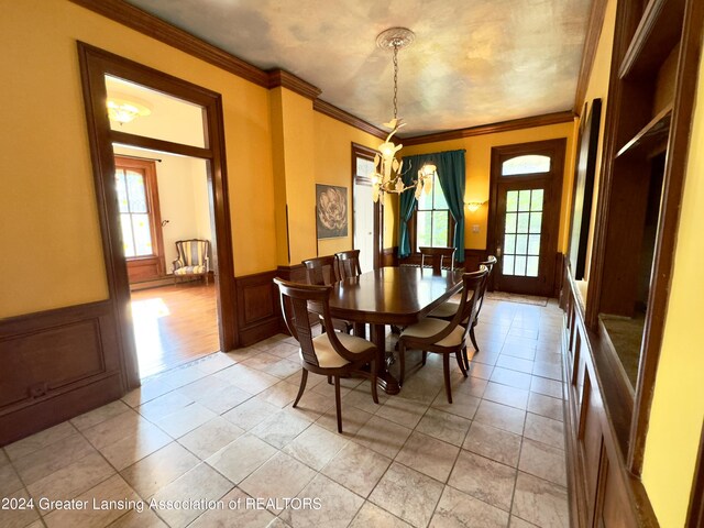 tiled dining room featuring ornamental molding