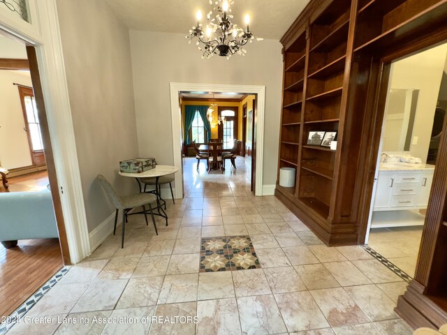 corridor featuring a chandelier and sink