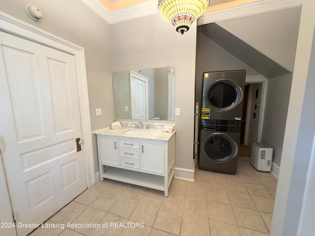 bathroom featuring tile patterned flooring, vanity, ornamental molding, and stacked washer / drying machine